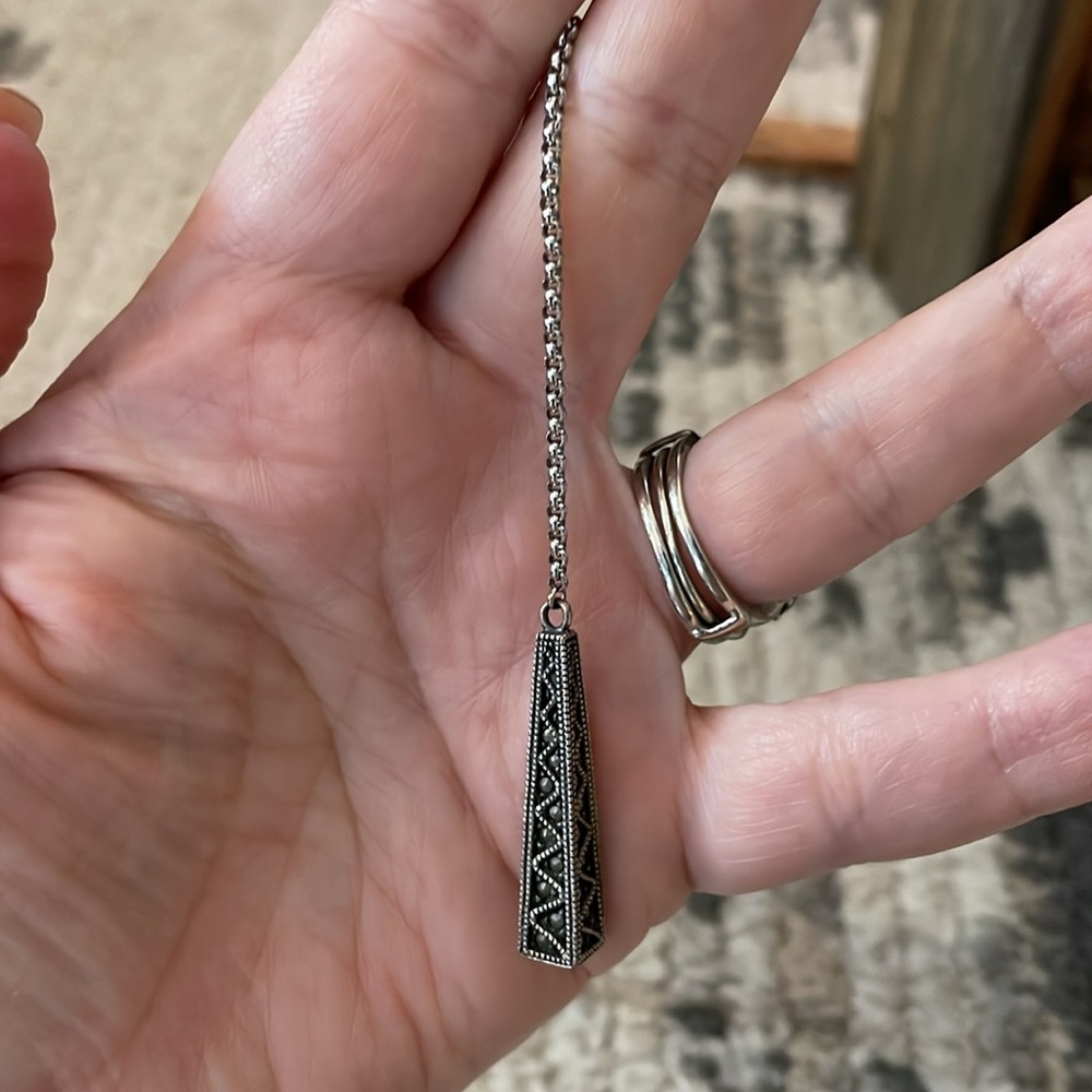 Sterling pendulum pendant on lariat rololink necklace. The pendant is marked 925